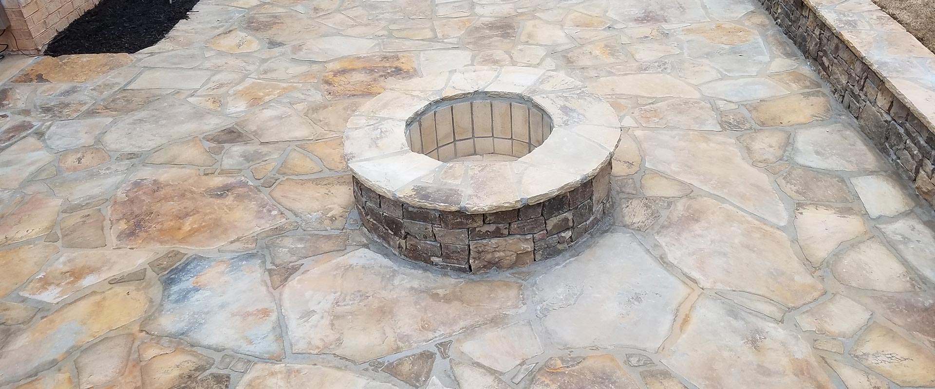 fllagstone patio with a firepit