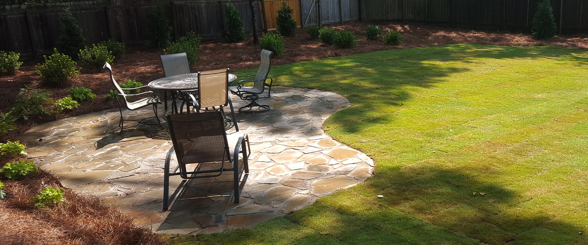 backyard flagstone patio with garden furniture