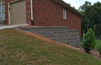 retaining wall next to a garage