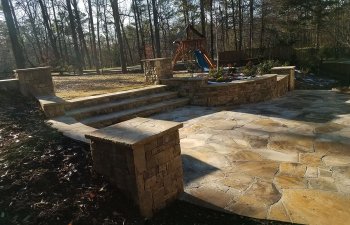 flagstone patio with steps to a garden