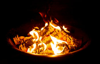 fire pit at night showing glowing embers