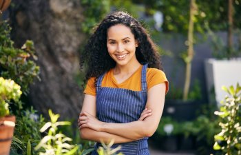 Outdoor, florist and smile for portrait, woman and entrepreneur with apron, spring and growth of plants. Small business, nature and person in garden, ecology and service for shop, green and happy